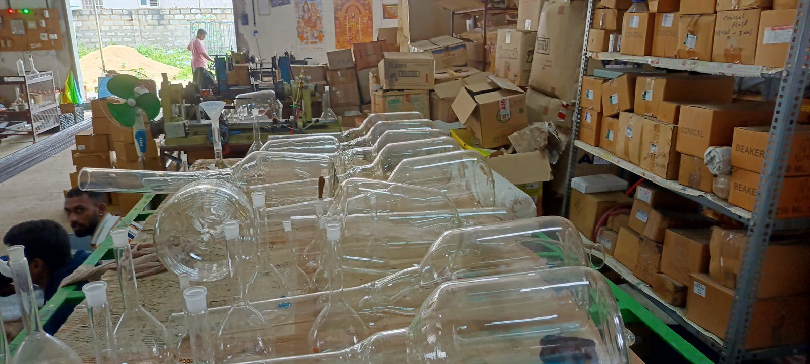 Production floor with scientific glassware and team members